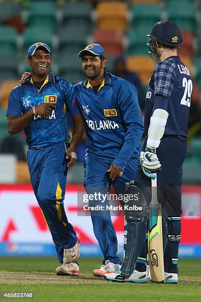 Seekkuge Prasanna and Lahiru Thirimanne of Sri Lanka celebrate the wicket of Michael Leask of Scotland during the 2015 Cricket World Cup match...