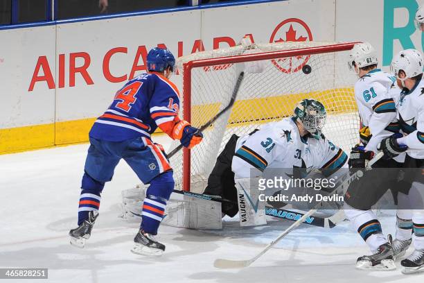 Jordan Eberle of the Edmonton Oilers scores a goal on Antti Niemi of the San Jose Sharks on January 29, 2014 at Rexall Place in Edmonton, Alberta,...