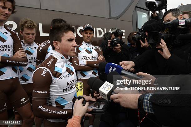 France's Samuel Dumoulin reads a statement to journalists, flanked by teammates of the France's AG2R La Mondiale cycling team, Belgium's Johan Van...