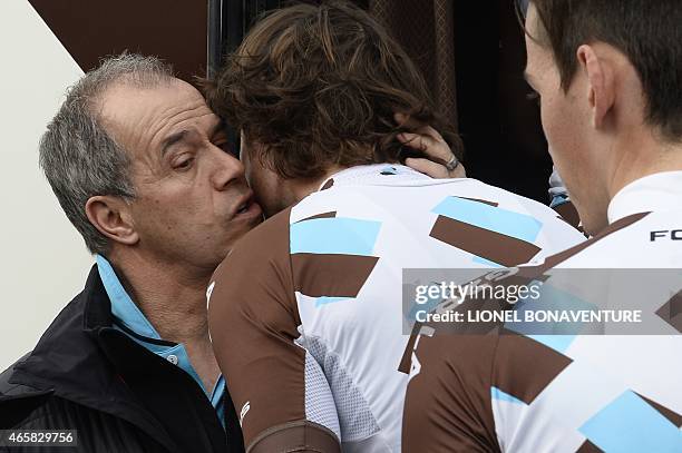 Manager of the France's AG2R La Mondiale cycling team, Vincent Lavenu kisses Belgium's Johan Van Summeren , next to France's Romain Bardet on March...