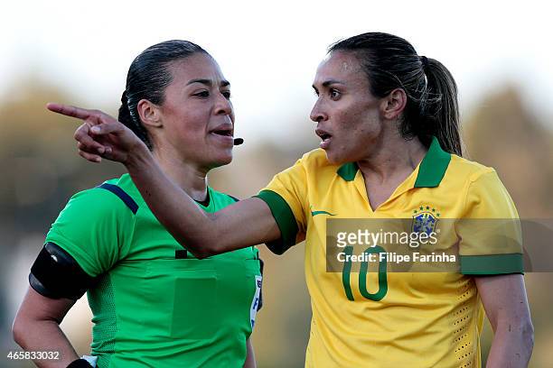 Marta Silva of Brazil, next to Melissa Borjas, argues with the assistant referee during the Women's Algarve Cup match between Brazil and Germany on...