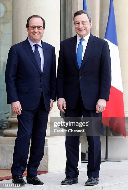 French President Francois Hollande welcomes Mario Draghi, president of the European Central Bank prior a meeting at the Elysee Palace on March 11,...