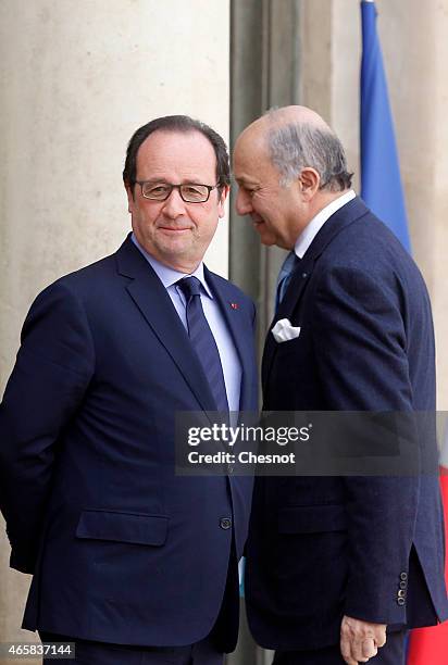 French President Francois Hollande and Laurent Fabius, French Minister of Foreign Affairs and International Development wait for a meeting with Mario...