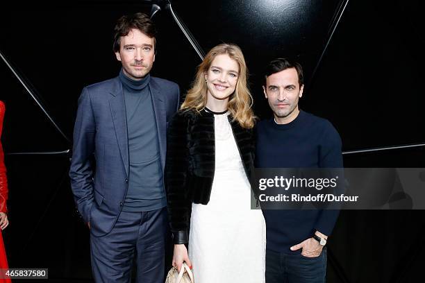 Fashion Designer Nicolas Ghesquiere standing between Model Natalia Vodianova and General manager of Berluti Antoine Arnault pose after the Louis...