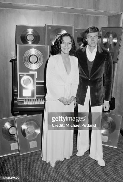 American pop duo The Carpenters, Karen Carpenter and her brother Richard, with awards for sales of their albums, 22nd February 1974.