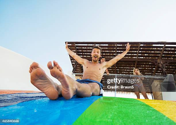 cheerful people having fun at water park. - waterslide stock pictures, royalty-free photos & images