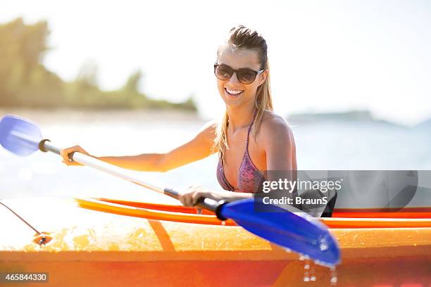 young woman kayaking during summer day. - zeekajakken stockfoto's en -beelden