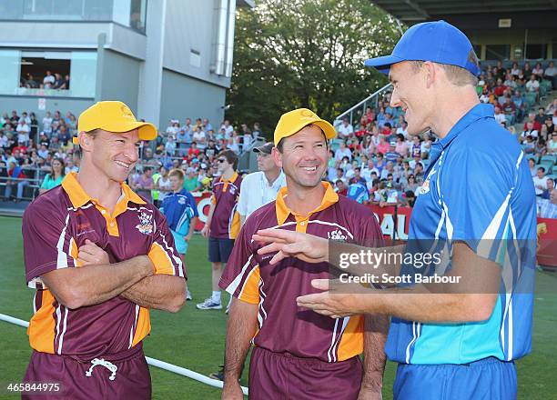 Ricky Ponting talks with AFL footballers Brent Harvey and Drew Petrie during the Ricky Ponting Tribute Match at Aurora Stadium on January 30, 2014 in...