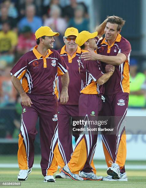 Ricky Ponting looks on as AFL footballer Brent Harvey congratulates Matthew Richardson after he dismissed Adam Gilchrist during the Ricky Ponting...