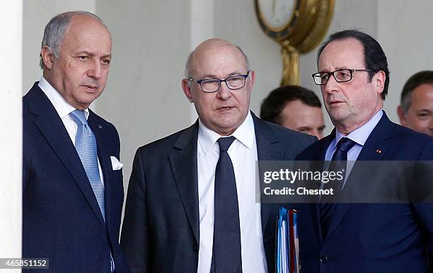 French President Francois Hollande talks with Laurent Fabius , French Minister of Foreign Affairs and International Development and Michel Sapin ,...