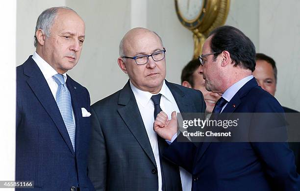 French President Francois Hollande talks with Laurent Fabius , French Minister of Foreign Affairs and International Development and Michel Sapin ,...