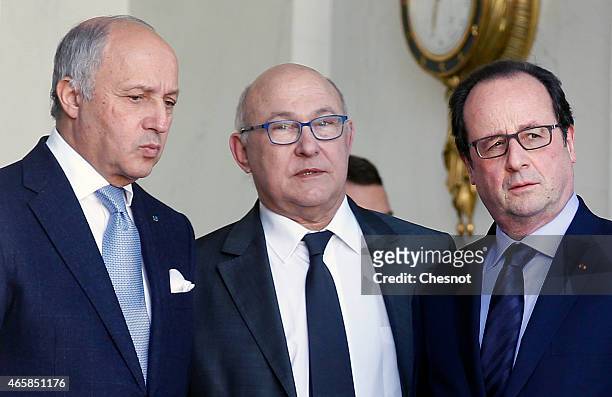 French President Francois Hollande talks with Laurent Fabius , French Minister of Foreign Affairs and International Development and Michel Sapin ,...