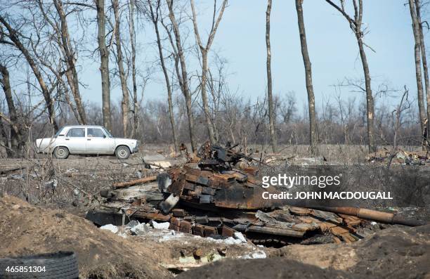 Ukrainian tank sits near the town of Nikishyne, southeast of Debaltseve, on March 11, 2015. The town was levelled in fighting between Ukrainian...