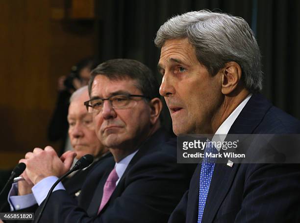 Secretary of State John Kerry testifies while flanked by Defense Secretary Ashton Carter and Chairman of the Joint Chiefs of Staff Gen. Martin...