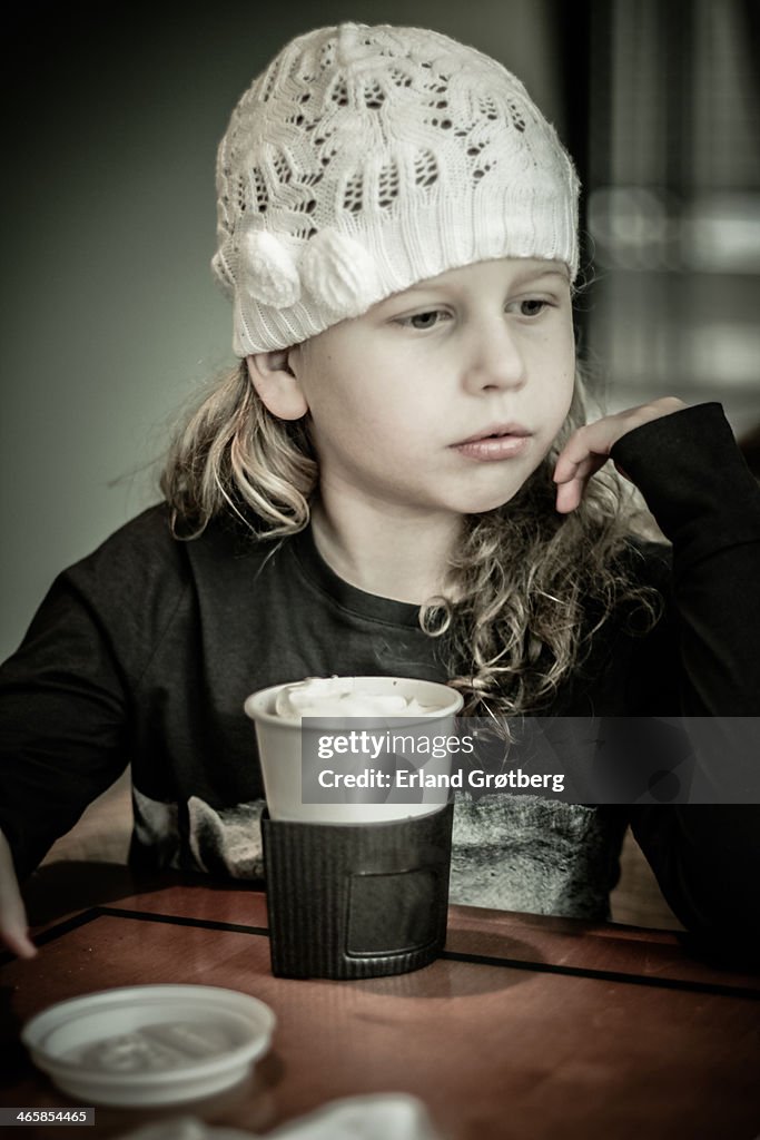 Girl having hot chocolate at a coffee shop