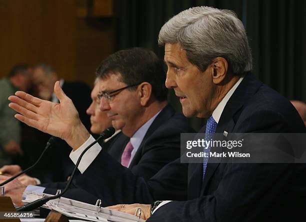 Secretary of State John Kerry testifies while flanked by Defense Secretary Ashton Carter and Chairman of the Joint Chiefs of Staff Gen. Martin...