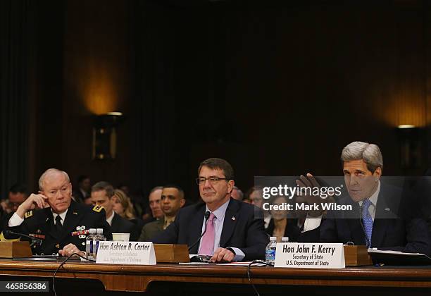 Secretary of State John Kerry testifies while flanked by Defense Secretary Ashton Carter and Chairman of the Joint Chiefs of Staff Gen. Martin...