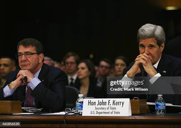 Secretary of State John Kerry and Defense Secretary Ashton Carter listen to questions during a Senate Foreign Relations Committee hearing on Capitol...