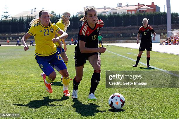 Fatmire Alushi of Germany is challenged by Elin Rubensson of Sweden during the Women's Algarve Cup 3rd place match between Sweden and Germany at...