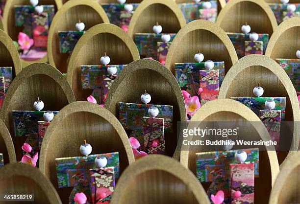 Kaguyabina, a pair of paper dolls placed inside a bamboo container for Hinamatsuri ddsplay after completed at Matsui Kogeisha doll workshop on...