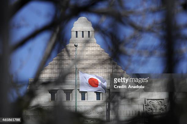 The Japan Flag is seen flying at half-mast on the Diet Building in Tokyo, Japan, March 11, 2015. Japan commemorates the 4th anniversary of the death...