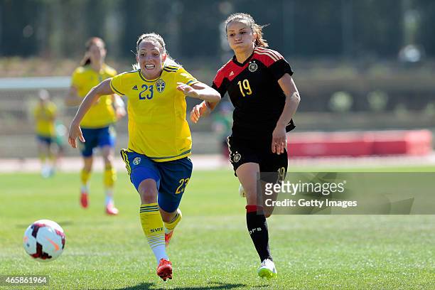 Elin Rubensson of Sweden is challenged by Fatmire Alushi of Germany during the Women's Algarve Cup 3rd place match between Sweden and Germany at...