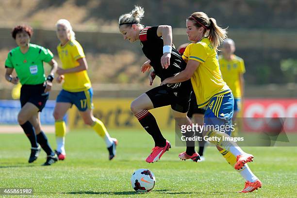 Alexandra Popp of Germany is challenged by Hanna Folkesson of Sweden during the Women's Algarve Cup 3rd place match between Sweden and Germany at...