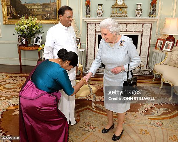 Britain's Queen Elizabeth II welcomes Sri Lankan President Maithripala Sirisena and his wife Jayanthi during a private audience at Buckingham Palace,...
