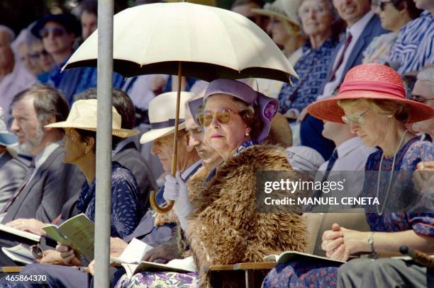 British Queen Elizabeth II , shielding herself from the sun with an umbrella, Prince Philip, Duke of Edinburgh , New Zealand Prime Minister Geoffrey...