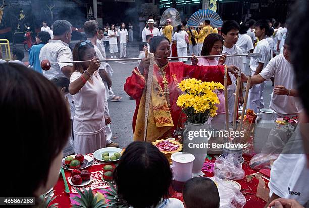 Chinese devotees parade through the streets of Phuket as part of the world famous vegetarian festival in which devotees have their bodies pierced in...