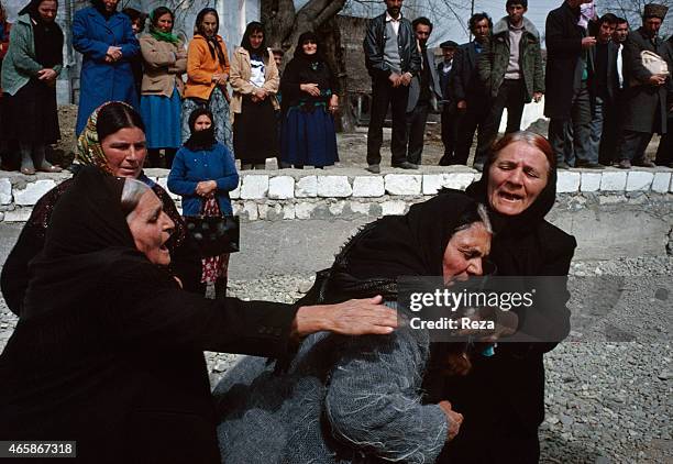 Women console each other after finding the dead bodies of their relatives at a makeshift morgue in February 1992 in Aghdam, Azerbaijan, following a...