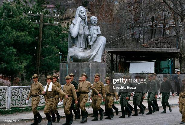 Azerbaijani soldiers march past a Soviet-era statue of a mother and child in Fuzuli, Karabakh, Azerbaijan, in May 1992. Fuzuli was circled by...