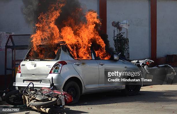 Car set alight by angry lawyers outside the district court after a police inspector shot a lawyer in the court premises on March 11, 2015 in...