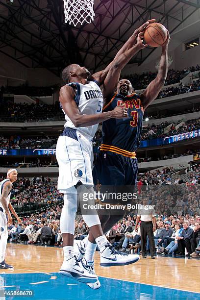 Kendrick Perkins of the Cleveland Cavaliers drives to the basket against Bernard James of the Dallas Mavericks on March 10, 2015 at the American...