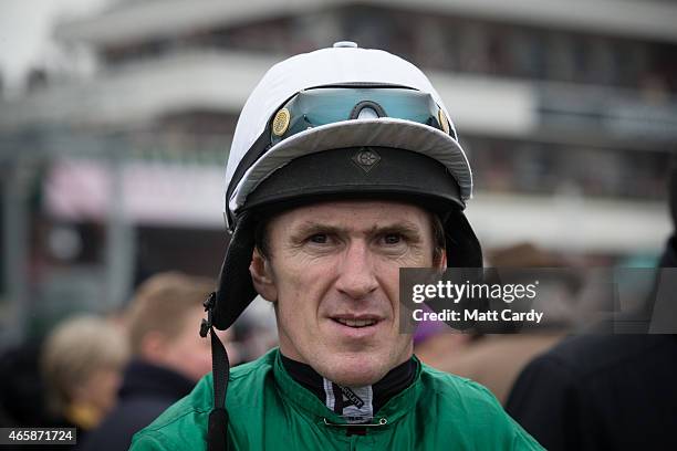 Jockey AP McCoy watches horses being paraded in the paddock on the second day of the Cheltenham Festival on March 11, 2015 in Cheltenham, England....