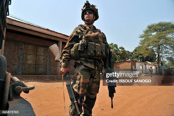 French soldier of the Sangaris operation holds a shotgun confiscated from a looter during a patrol in Bangui on January 30, 2014. Unrest continues in...