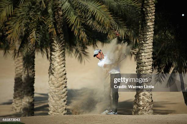 Pablo Larrazabal of Spain plays his second shot on the 14th hole during the first round of the 2014 Omega Dersert Classic on the Majlis Course at the...