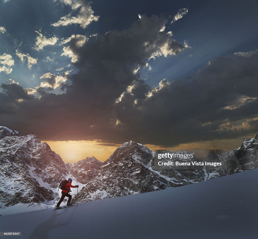 Lone climber on a snowy slope at sunrise