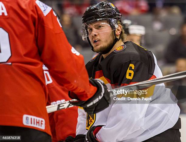 Forward Parker Tuomie of Germany battles for the puck against Switzerland during the 2015 IIHF World Junior Championship on January 02, 2015 at the...