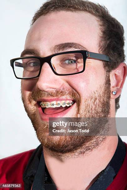 man smiling with braces and glasses on white - adult retainer ストックフォトと画像