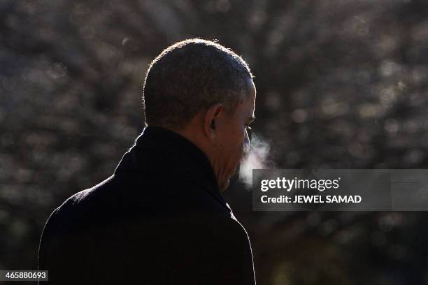 President Barack Obama walks to board Marine One as he leaves from the White House in Washington, DC, on January 30, 2014 en route to Milwaukee,...