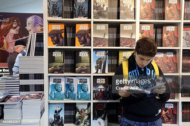 Boy reads the US comic book 'The walking dead' on the first day of the 'Festival international de la bande dessinee' in Angouleme, on January 30,...