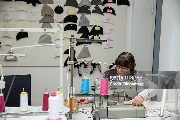 An employee works at a sewing machine inside the fashion design studio at the headquarters of Hennes & Mauritz AB in Stockholm, Sweden, on Thursday,...