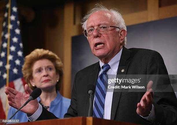 Senate Budget Committee ranking member Bernie Sanders speaks about ending sequestration while flanked by Sen. Debbie Stabenow , during a news...