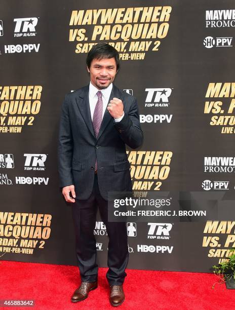 Boxer Manny Pacquiao gestures while posing on arrival March 11, 2015 in Los Angeles, California for the Floyd Mayweather vs Manny Pacquiao press...
