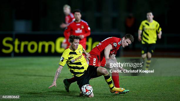 Tobias Ruehle of Sonnenhof Grossaspach challenges Erik Durm of Dortmund II during the Third League match between Borussia Dortmund II and SG...