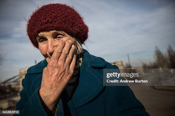 Woman who would only identify herself as Lydia cries while talking about the last few months on March 11, 2015 in Chornukyne, Ukraine. Chornukyne, a...