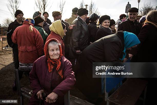 Elderly women wait for pro-Russian rebels to hand out humanitarian aid on March 11, 2015 in Chornukyne, Ukraine. Chornukyne, a small village east of...