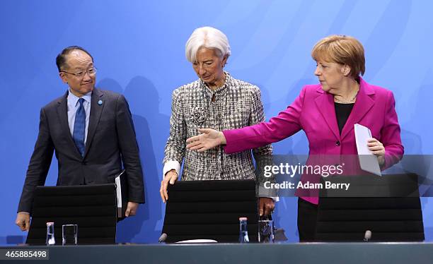 World Bank Group President Jim Yong Kim, International Monetary Fund Managing Director Christine Lagarde and German Chanceller Angela Merkel attend a...