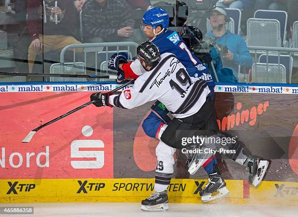 Jason Jaspers of the Thomas Sabo Ice Tigers Nuernberg gives a Bodycheck to Sinan Akdag of the Adler Mannheim during the game between Adler Mannheim...